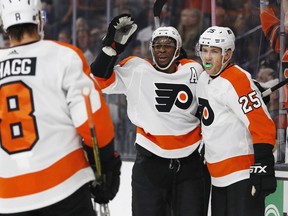 Philadelphia Flyers' James van Riemsdyk, right, celebrates after Wayne Simmonds, center, scored against the Vegas Golden Knights during the first period of an NHL hockey game Thursday, Oct. 4, 2018, in Las Vegas.