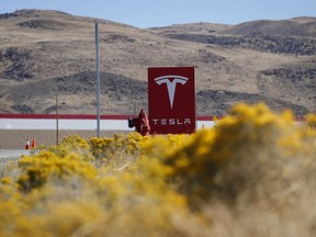 In this Oct. 13, 2018, photo, a sign marks the entrance to the Tesla Gigafactory in Sparks, Nev. A population inrush to Nevada has been driven by people seeking more affordable housing and a growing tech industry around Reno.