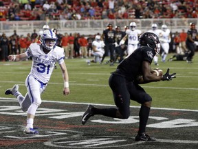 UNLV wide receiver Darren Woods Jr. (10) pulls in a touchdown pass ahead of Air Force defensive back Ross Connors (31) during the first half of an NCAA college football game in Las Vegas, Friday, Oct. 19, 2018.