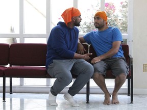In this Oct. 3, 2018 photo, Satyawart, left, and Balvinder Singh, immigrants from India freed from the federal prison in Sheridan, Ore., talk at the Dasmesh Darbar Sikh temple in Salem, Ore. After Trump's zero-tolerance policy recently sent immigrant detainees to a federal prison in rural Oregon, more than 100 lawyers, retirees, recent college graduates, clergy and others in the area stepped up to help out.