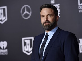 FILE - In this Nov. 13, 2017 file photo, Ben Affleck, a cast member in "Justice League," poses at the premiere of the film at the Dolby Theatre in Los Angeles.   Affleck says battling addiction is "a lifelong and difficult struggle." The actor posted on Instagram Thursday, Oct. 4, 2018,  that he has completed a 40-day stay at a treatment center for alcohol addiction and remains in outpatient care.