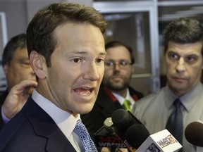 FILE - In this Feb. 6, 2015 file photo, then-Illinois Rep. Aaron Schock speaks to reporters in Peoria Ill.  Schock's public corruption trial is now scheduled for June 2019 in federal court in Chicago. Schock was once a rising star in Congress and a formidable GOP fundraiser. He is accused of using campaign money and his congressional allotment for personal expenses and extravagant redecorating of his Capitol Hill office in the style of the TV series "Downton Abbey."