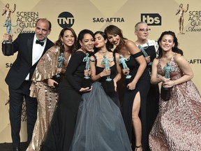 FILE - In this Sunday, Jan. 29, 2017 file photo, Nick Sandow, from left, Elizabeth Rodriguez, Selenis Leyva, Diane Guerrero, Jackie Cruz, Lori Petty and Yael Stone pose in the press room with the award for outstanding performance by an ensemble in a comedy series for "Orange Is The New Black" at the 23rd annual Screen Actors Guild Awards at the Shrine Auditorium & Expo Hall in Los Angeles. "Orange Is the New Black" is fading to black after its upcoming seventh season. Cast members posted a video Wednesday, Oct. 17, 2018 announcing the series' 2019 end, which was confirmed by a Netflix spokeswoman.
