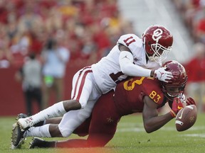 FILE - In this Sept. 15, 2018, file photo, Oklahoma cornerback Parnell Motley, top, breaks up a pass intended for Iowa State wide receiver Jalen Martin, right, during the first half of an NCAA college football game, in Ames, Iowa. Last season gave Iowa State hope that its decades of irrelevance might soon be over. This season has been a painful reminder that the path to national relevance isn't always linear.