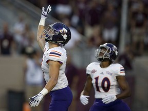FILE - In this Aug. 30, 2018, file photo, Northwestern State's Ryan Reed (8) waves for a fair catch on the opening kickoff against Texas A&M during an NCAA college football game, in College Station, Texas. About 1 of every 10 kickoffs in the Football Bowl Subdivision have resulted in a fair catch giving the return team possession at its 25-yard line under a rule that went into effect this year. The purpose of the rule was to minimize kick returns, which have a higher injury rate compared with other types of plays. If a fair catch is made anywhere between the goal line and 25, it's a touchback and it's marked at the 25.