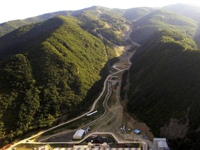 FILE -This Sept. 9, 2018, file photo, shows an aerial view of the downhill slope of the 2018 Pyeongchang Winter Olympics at the Jeongseon Alpine Center in Jeongseon, South Korea. Pyeongchang is already considering razing some of the venues it built for this year's Winter Games because there's simply no use for them, while Tokyo is reportedly set to spend a staggering $25 billion on the next Summer Games