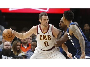 FILE - In this Oct. 19, 2018, file photo, Cleveland Cavaliers' Kevin Love, left, is double-teamed by Minnesota Timberwolves' Anthony Tolliver and Jeff Teague, right, in the first half of an NBA basketball game, in Minneapolis. Love could miss significant time with a foot injury that has bothered him since the preseason. Love will sit out his third straight game on Tuesday, Oct. 30, 2018, as the winless Cavs host Atlanta and look to end a six-game winless streak to start the season.