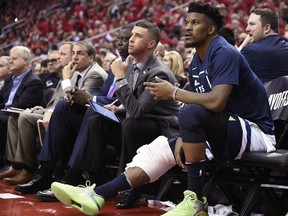 FILE - In this April 25, 2018, file photo, Minnesota Timberwolves guard Jimmy Butler, right, watches from the bench during the second half in Game 5 of the team's first-round NBA basketball playoff series against the Houston Rockets, in Houston. With Butler's status still unresolved, coach Tom Thibodeau and the Timberwolves head toward the season coming off the franchise's first playoff appearance in 14 years but carrying yet a still-cloudy outlook despite the super-max contract Karl-Anthony Towns.