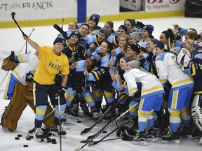 FILE - In this Jan. 24, 2016, file photo, National Women's Hockey League All-Star players take time for a "selfie" before the start of an all-star game at Harborcenter in Buffalo, N.Y.  NWHL founder and commissioner Dani Rylan tells The Associated Press she considers the likelihood of North America having one women's professional hockey league as being "inevitable." Rylan's comments, made in an email to The AP, are considered her strongest regarding a potential merger with the rival Canadian Women's Hockey League since the NWHL was formed three years ago.