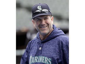 FILE - In this April 23, 2018, file photo, Seattle Mariners' hitting coach Edgar Martinez smiles during batting practice before a baseball game against the Chicago White Sox, in Chicago. Martinez is stepping down as the hitting coach for the Seattle Mariners and moving into a new role as a hitting adviser for the entire organization, the club announced on Tuesday, Oct. 30, 2018. The move means Martinez will have more freedom to work with all levels of the organization.