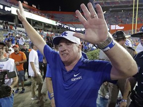 FILE - In this Sept. 8, 2018, file photo, Kentucky head coach Mark Stoops waves to fans after defeating Florida 21-16 in an NCAA college football game, in Gainesville, Fla.  Unbeaten Kentucky may be the SEC's biggest surprise.