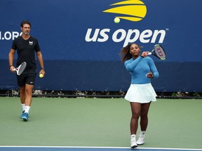 FILE - In this Aug. 31, 2018, file photo, Serena Williams walks on a practice court with her coach, Patrick Mouratoglou, during the third round of the U.S. Open tennis tournament,  in New York. Serena Williams' coach says in-match coaching should be allowed in tennis to help the sport's popularity. Mouratoglou, who admitted he used banned hand signals to try to help Williams during her loss in the U.S. Open final, wrote Thursday, Oct. 18, 2018, in a posting on Twitter that legalizing coaching and making it part of the spectacle would let "viewers enjoy it as a show."