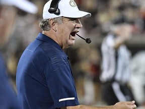 FILE - In this Oct. 5, 2018, file photo, Georgia Tech head coach Paul Johnson shouts instructions to his team during the first half of an NCAA college football game against Louisville,  in Louisville, Ky. Georgia Tech has had time to stew during its bye week, but the Yellow Jackets are neither lamenting their tough schedule, ruing a few dreadful losses nor contemplating the complexities required to save their season. The Yellow Jackets (3-4, 1-3 Atlantic Coast Conference) have been working on a seemingly simple skill _ hanging onto the football.