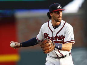 FILE - In this May 30, 2018, file photo, Atlanta Braves shortstop Dansby Swanson (7) warms up before the first inning of a baseball game against the New York Mets, in Atlanta. The Braves are trying to determine the status of shortstop Dansby Swanson, who has a sore wrist, as they prepare to open their NLDS against the Los Angeles Dodgers .