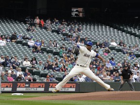 FILE - In this Sept. 30, 2018, file photo, empty seats are shown at Safeco Field as Seattle Mariners starting pitcher Roenis Elias throws against the Texas Rangers during the first inning of a baseball game, in Seattle. Major League Baseball's attendance dropped to its lowest level since 2003, and six stadiums set record lows.