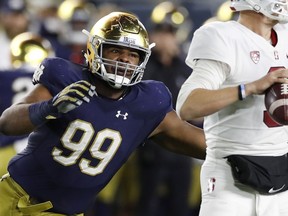 FILE - In this Sept. 29, 2018, file photo, Notre Dame defensive lineman Jerry Tillery rushes Stanford quarterback K.J. Costello during the second half of an NCAA college football game, in South Bend, Ind. Tillery, a 6-foot-7, 305-pound senior, has been the anchor of No. 6 Notre Dame's defense all season, but he went off against Stanford. Tillery had a career-best four sacks and now is tied for the national lead with seven.
