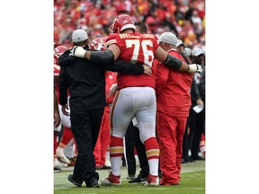 FILE - In this Sunday, Oct. 7, 2018 file photo,Kansas City Chiefs offensive lineman Laurent Duvernay-Tardif (76) is helped off the field during the second half of an NFL football game against the Jacksonville Jaguars in Kansas City, Mo. The Chiefs placed right guard Laurent Duvernay-Tardif and safety Armani Watts on injured reserve Tuesday, Oct. 9, 2018 and signed outside linebacker Frank Zombo to provide depth at that depleted position.