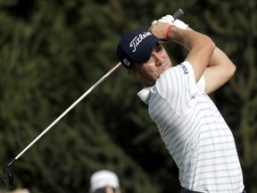 FILE - In this Thursday, Aug. 23, 2018 file photo, Justin Thomas tees off on the 14th hole during the first round of the Northern Trust golf tournament in Paramus, N.J. Tiger Woods finished off the PGA Tour season by tapping in for par to win the Tour Championship, a moment that ended any doubts that he could win again after four surgeries on his lower back. And then the moment was gone as the Ryder Cup began. Overlooked from last season was Justin Thomas being first player to win consecutive money titles since Woods, and Woods winning a fifth tournament in three decades.