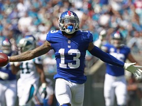 FILE- In this Sunday, Oct. 7, 2018, file photo, New York Giants' Odell Beckham (13) celebrates a catch against the Carolina Panthers in the first half of an NFL football game in Charlotte, N.C. The co-owner of the New York Giants is embarrassed by the team's second straight 1-5 start and he wants star receiver Odell Beckham Jr. to make his highlights on the field instead of getting recognition from off-the-field comments.