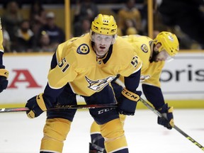 FILE - In this April 14, 2018, file photo, Nashville Predators left wing Austin Watson waits for play to resume during the team's NHL hockey playoff game against the Colorado Avalanche in Nashville, Tenn.Watson's 27-game suspension for domestic abuse has been reduced to 18 games by an arbitrator. The NHL and the NHL Players' Association announced arbitrator Shyam Das' decision Thursday, Oct. 11.