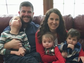In this Dec. 10, 2017 photo provided by the family, Jon and Kari Kilquist sit with their children, from left, Will, Emmy and Owen at their home in Murphysboro, Ill. Will was born with a long list of mysterious symptoms that require a wheelchair, feeding tube and other care but his doctors were stumped at the cause. A new national network that tackles the rarest of rare diseases finally gave his family a diagnosis, finding he was the only known patient in the world _ so far _ to harbor a particular gene mutation that caused his health problems. (Kilquist Family via AP)