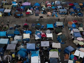FILE - This Wednesday, Oct. 11, 2017 file photo shows a large homeless encampment at the Santa Ana Civic Center in Santa Ana, Calif. On Wednesday, Oct. 24, 2018, a U.S. advisory committee recommended routine hepatitis A vaccinations for homeless people, following an increase in outbreaks of the contagious liver disease.