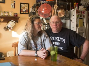 FILE - In this Friday, July 7, 2017 photo, Tammie Jackson, and her husband, Travis, discuss their Medicaid program benefits at their home in Helena, Mont. Tammie, who was uninsured until she enrolled in Montana's expanded Medicaid program, receives medical care for a host of health issues, including a back injury that has kept from returning to her job cleaning hotel rooms. In 2018, Montana seeks to raise a tobacco tax to keep funding a Medicaid expansion that is set to expire.
