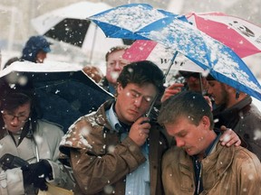 FILE - In this Oct. 16, 1998 file photo, Brian Harrington, right, and Chuck Beauchine pray with other mourners during the funeral of Matthew Shepard at St. Mark's Episcopal Church in Casper, Wyo. Shepard, an openly gay University of Wyoming student, died from a beating in Laramie, that's widely considered to have been at least in part motivated by his sexual orientation.  The murder of Shepard was a watershed moment for gay rights and LGBTQ acceptance in the U.S., so much so that 20 years later the crime remains seared into the national consciousness.