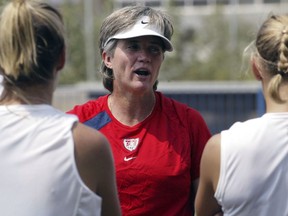 FILE - In this Aug. 5, 2004, file photo, United States women's soccer coach April Heinrichs talks with players during a team training session in Athens, Greece. Former national team coach and player Heinrichs will step down director of the women's youth national teams for U.S. Soccer at the end of this year.