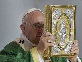 FILE - In this Sunday, Sept. 27, 2015 file photo, Pope Francis holds the Gospel Book during a Mass on the Benjamin Franklin Parkway in Philadelphia. As sex abuse scandals continue to buffet the Roman Catholic Church, Catholics in the U.S. are steadily losing confidence in Pope Francis' handling of the crisis, according to a new survey by the Pew Research Center, released on Tuesday, Oct. 2, 2018.