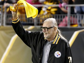 FILE - In this Oct. 1, 2015, file photo, horror film director George Romero, who directed "The Night of The Living Dead" waves a Terrible Towel before an NFL football game between the Pittsburgh Steelers and the Baltimore Ravens in Pittsburgh. Pittsburgh is set to honor the father of modern American zombie films outside the theater where his "Night of the Living Dead" premiered 50 years ago. The widow of Romero, Mayor Bill Peduto and others will gather at 10:30 p.m. Monday, Oct. 1, 2018.