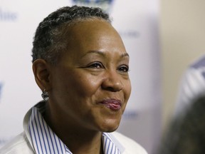 FILE - In this May 21, 2016, file photo, WNBA President Lisa Borders smiles as she speaks to reporters before a WNBA basketball game between the San Antonio Stars and the Dallas Wings in Arlington, Texas. TIME'S UP has named Borders as its first president and CEO. In a statement Tuesday, Oct. 2, 2018, the organization said Borders will lead the organization's efforts to "ensure equal opportunity and protection for all working women."