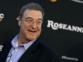 FILE - In this March 23, 2018, file photo, John Goodman arrives at the Los Angeles premiere of "Roseanne" in Burbank, Calif. Cast members of the "Roseanne" revival are looking forward to their spinoff "The Conners." Goodman, Sara Gilbert and Laurie Metcalf discuss Roseanne Barr's racist tweet in a story that will appear in the Oct. 15 edition of People magazine.