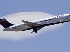 FILE- In this May 24, 2018, file photo a Delta Air Lines passenger jet plane, a Boeing 717-200 model, approaches Logan Airport in Boston. Delta is partnering with a pet travel pod startup, as it changes its prices and policy for transporting passengers' animal companions, the airline announced Tuesday, Oct. 2.