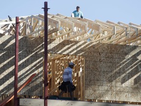 FILE- In this Aug. 30, 2018, file photo a workers toil on a new home under construction in Denver. On Wednesday, Oct. 17, the Commerce Department reports on U.S. home construction in September.
