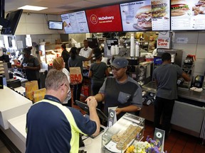 FILE- In this July 18, 2018, file photo a customer gets his coffee at a McDonald's restaurant in Pittsburgh. On Wednesday, Oct. 3, the Institute for Supply Management, a trade group of purchasing managers, issues its index of non-manufacturing activity for September.