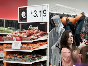 FILE- In this Oct. 3, 2018, file photo Sophia Narvaez, looks at Halloween decorations at a Target department store in Pembroke Pines, Fla. On Thursday, Oct. 11, the Labor Department reports on U.S. consumer prices for September.