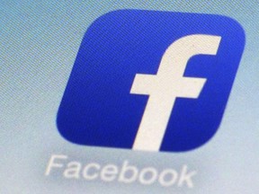 FILE - This Feb. 19, 2014, file photo, shows a Facebook app icon on a smartphone in New York. South Korea's telecoms regulator says it is fining Facebook for illegally limiting user access to its services. Facebook says hackers accessed data from 29 million accounts as part of the security breach disclosed two weeks ago.