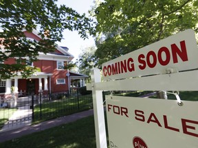 FILE- In this Aug. 30, 2018, file photo a sale signs stand outside a home on the market in Denver. On Friday, Oct. 19, the National Association of Realtors reports on sales of existing homes in September.