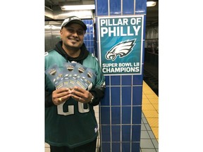 In this October 2018 photo provided by Matt Liston, Philadelphia Eagles fan Jigar Desai poses with tickets to an Oct. 28 football game between the Eagles and the Jacksonville Jaguars in front of the subway pillar he ran into earlier this year at Ellsworth Station on the Broad Street subway line in Philadelphia. The moment in the spotlight isn't over yet for Desai who stumbled into fame as a viral video star after running into the subway pillar. Desai is now the subject of an NFL digital short feature, shot ahead of the Oct. 28 Eagles game against the Jacksonville Jaguars in London.