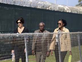 FILE - In this Nov. 15, 2017 file photo, Wilbert Jones, center,  leaves East Baton Rouge Parish Prison with Emily Maw, director of Innocence Project New Orleans, left, and Kia Hayes, IPNO staff attorney, in Baton Rouge, La. A legal ordeal that has dragged on for close to half a century is over for  Jones, a man wrongfully convicted in a 1971 rape. The advocacy group Innocence Project New Orleans said Thursday, Oct. 11, 2018, that prosecutors in Baton Rouge officially dismissed charges against Jones in the kidnapping and rape of a nurse at Baton Rouge General Hospital.