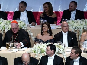 Keynote speaker Ambassador to the United Nations Nikki Haley, center, shares a light moment as she attends the 73rd Annual Alfred E. Smith Memorial Foundation Dinner Thursday, Oct. 18, 2018, in New York. Left is Archbishop of New York Cardinal Timothy Dolan, and right is Michael Haley, husband of Nikki Haley.