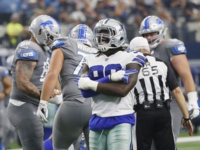 FILE - In this Sunday, Sept. 30, 2018, file photo, Dallas Cowboys defensive end Demarcus Lawrence (90) celebrates sacking Detroit Lions quarterback Matthew Stafford in the second half of an NFL football game in Arlington, Texas. Lawrence is leading the NFL in sacks early in the season for the second straight year. Playing on the franchise tag after finishing tied for second in sacks a year ago, the Dallas Cowboys defensive end is working toward an even bigger payday.