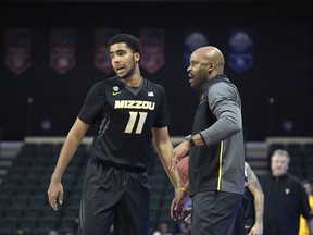 FILE - In this Nov. 26, 2017, file photo, Missouri coach Cuonzo Martin, right, gives instructions to forward Jontay Porter (11) during the second half of an NCAA college basketball game against West Virginia at the finals of the AdvoCare Invitational tournament in Lake Buena Vista, Fla. Porter returned to Missouri this season in the hopes of helping the Tigers to back-to-back NCAA Tournaments.