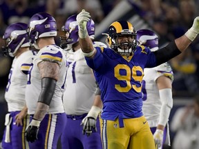 FILE - In this Thursday, Sept. 27, 2018, file photo, Los Angeles Rams defensive tackle Aaron Donald celebrates after sacking Minnesota Vikings quarterback Kirk Cousins during the second half in an NFL football game in Los Angeles. The 6-foot-1, 280-pound kingpin of the Rams defense was an unanimous pick for the best defensive tackle in the NFL by a panel of 10 football writers for The Associated Press in this week's edition of the position rankings.