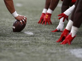 FILE - In this Saturday, Oct. 13, 2018, file photo, a Rutgers player, left,  prepares to snap the ball during the second half of an NCAA college football game against Maryland in College Park, Md. The best offensive lines are greater than the sum of their parts. Former Notre Dame star offensive lineman Aaron Taylor, now an analyst for CBS Sports, is one of the driving forces behind the Joe Moore Award, which honors the best offensive line in the college football.