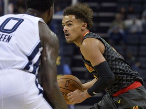 FILE - In this Friday, Oct. 5, 2018, file photo, Atlanta Hawks guard Trae Young, right, controls the ball against Memphis Grizzlies forward JaMychal Green (0) in the first half of an NBA preseason basketball game in Memphis, Tenn. The Hawks have begun a major rebuilding job. They have no star player, their point guard is a 20-year-old rookie, and their roster depth is suspect.