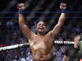 FILE - In this July 7, 2018, file photo, Daniel Cormier celebrates after defeating Stipe Miocic in a heavyweight title mixed martial arts bout at UFC 226 in Las Vegas. Cormier will defend the title against Derrick Lewis in the main event of UFC 230 on Nov. 3 against Madison Square Garden in New York.