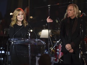 Honorees Marjorie Bach Walsh, left, and Joe Walsh speak at the Facing Addiction with NCADD (National Council on Alcoholism and Drug Dependence) gala at the Rainbow Room on Monday, Oct. 8, 2018, in New York.