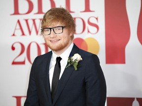 FILE - In this Feb. 21, 2018 file photo, singer Ed Sheeran poses for photographers upon arrival at the Brit Awards 2018 in London. Sheeran and his fiancé stopped in at Tommy Sullivan's Cafe in Branford, Conn., following a wedding Friday, Sept. 28. Pub owner Maeve Sullivan says the "Shape of You" singer ordered a beer before he was joined by others from the wedding party.